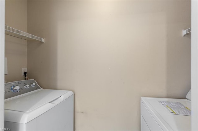 washroom featuring independent washer and dryer