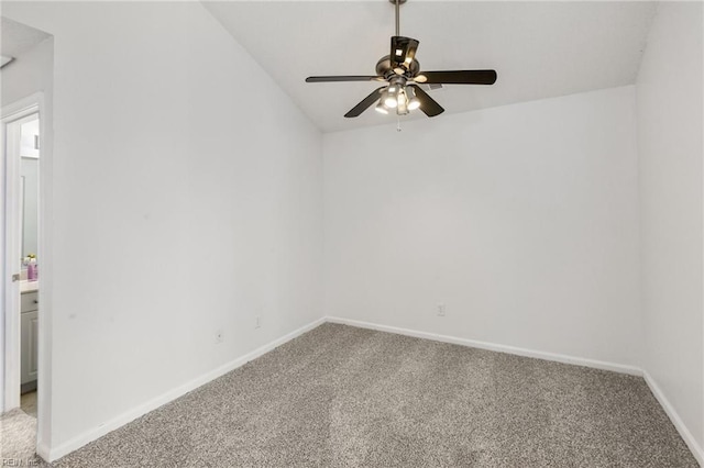 carpeted spare room featuring ceiling fan