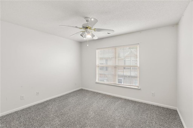 carpeted spare room with ceiling fan and a textured ceiling