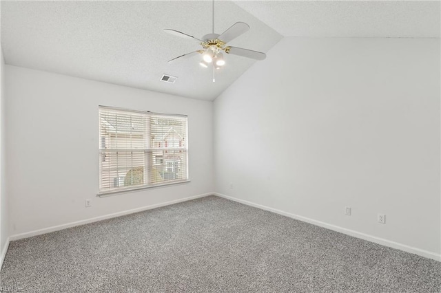 carpeted empty room featuring lofted ceiling, a textured ceiling, and ceiling fan