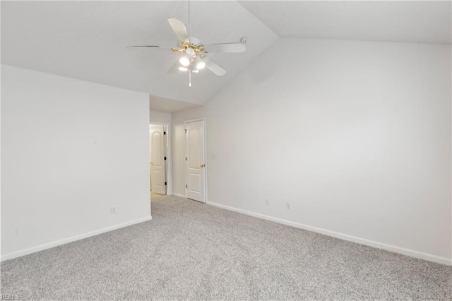 spare room with lofted ceiling, carpet floors, and ceiling fan