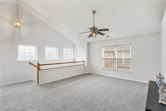 empty room featuring ceiling fan, carpet flooring, and high vaulted ceiling