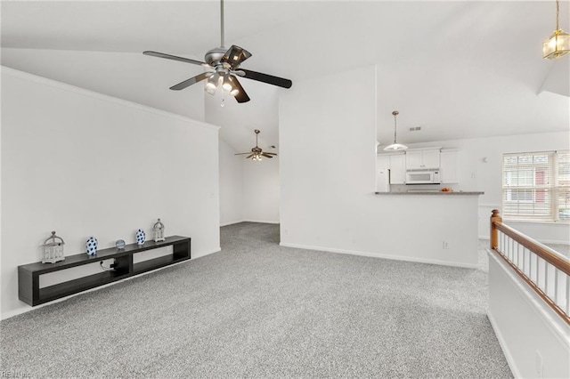 unfurnished living room with carpet and high vaulted ceiling