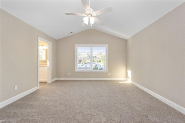 unfurnished room featuring lofted ceiling, light carpet, and ceiling fan