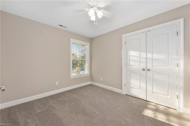 unfurnished bedroom featuring a closet, ceiling fan, and carpet