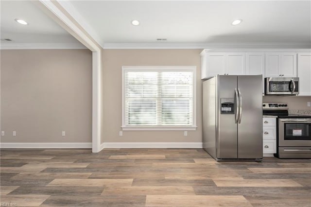 kitchen with ornamental molding, stainless steel appliances, light hardwood / wood-style floors, and white cabinets