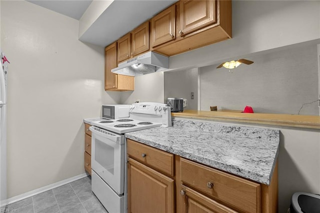 kitchen with light stone countertops, light tile patterned floors, and white electric stove