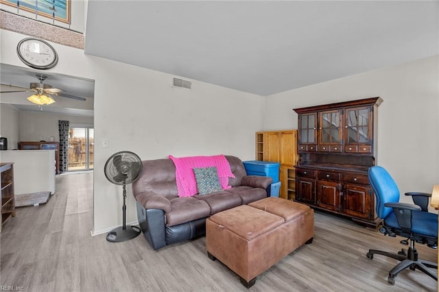 living room featuring ceiling fan and light wood-type flooring