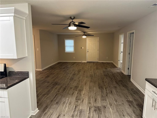 unfurnished living room with dark wood-type flooring