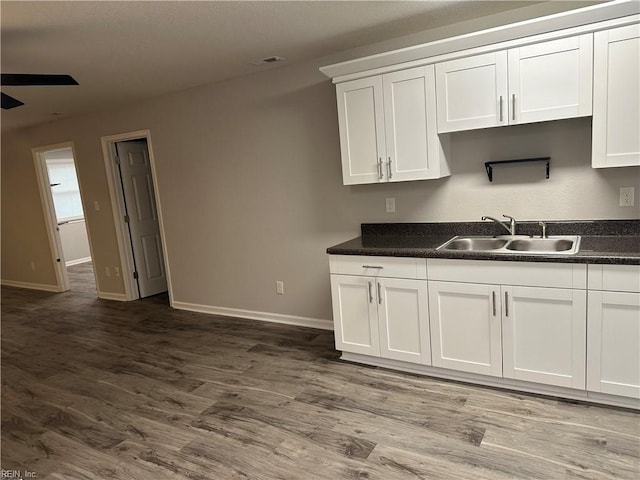 kitchen featuring white cabinetry, sink, ceiling fan, and dark hardwood / wood-style floors