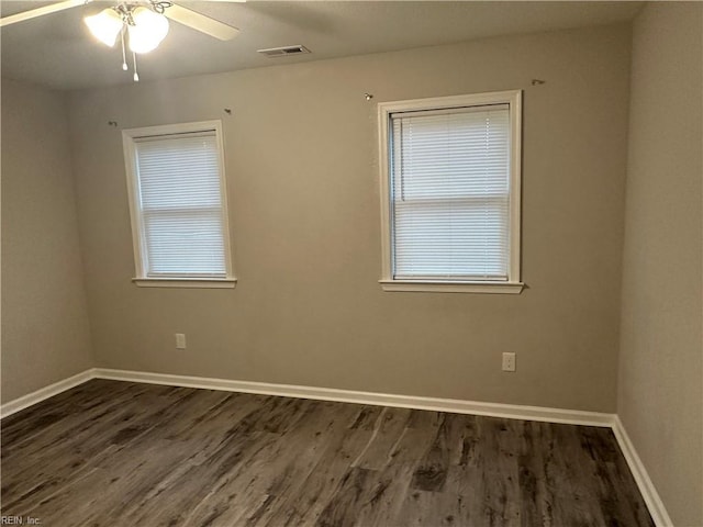 spare room with ceiling fan and dark hardwood / wood-style flooring