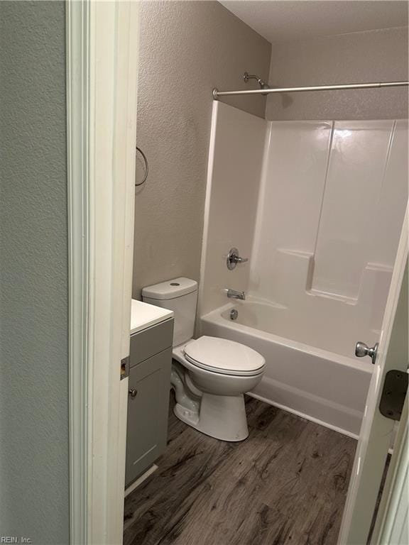 full bathroom with vanity, hardwood / wood-style flooring, toilet, and shower / bath combination