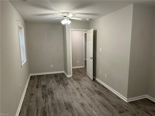 unfurnished room featuring dark hardwood / wood-style flooring, a textured ceiling, and ceiling fan