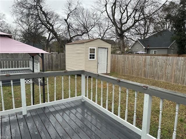 wooden deck with a storage shed and a yard