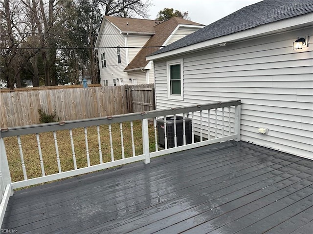 wooden deck with central AC unit and a lawn