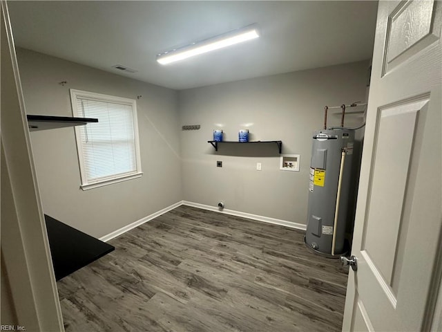 laundry area featuring water heater, washer hookup, dark wood-type flooring, and hookup for an electric dryer