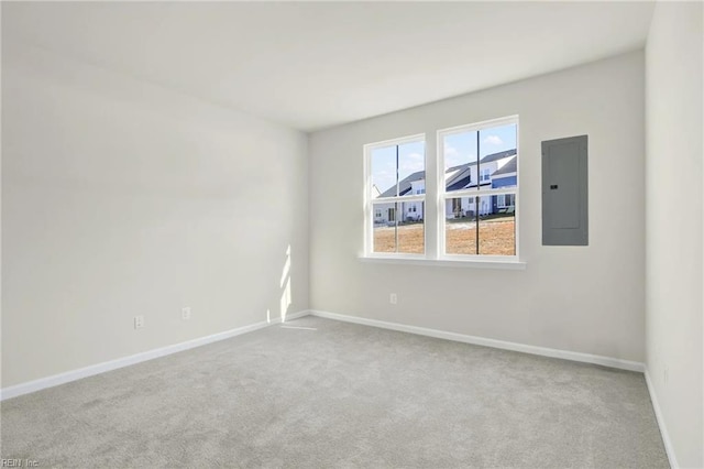 unfurnished room featuring light colored carpet and electric panel