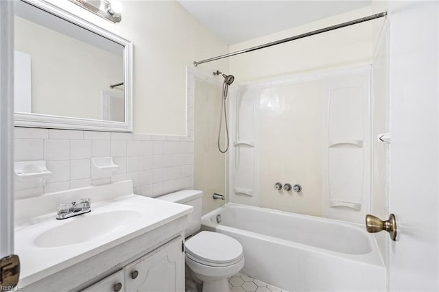 full bathroom with tile walls, vanity, shower / bathtub combination, and toilet