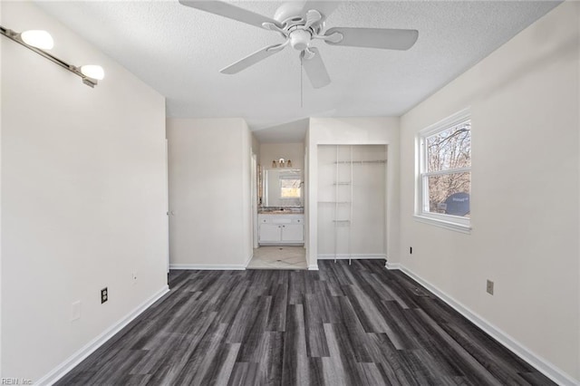 interior space with ceiling fan, a closet, dark hardwood / wood-style floors, and a textured ceiling