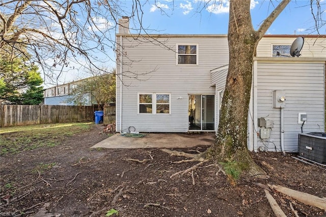 back of property with central AC unit and a patio area