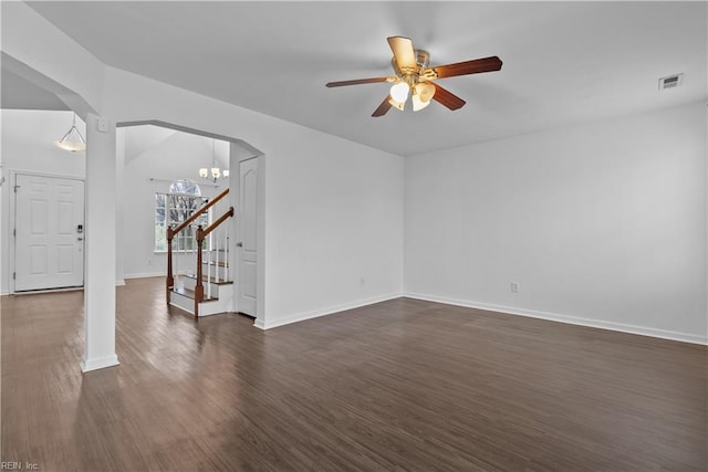 unfurnished living room featuring dark hardwood / wood-style floors and ceiling fan with notable chandelier