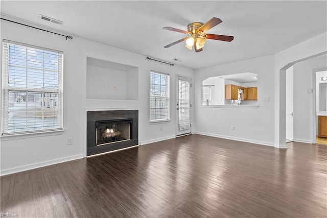 unfurnished living room with ceiling fan and dark hardwood / wood-style floors