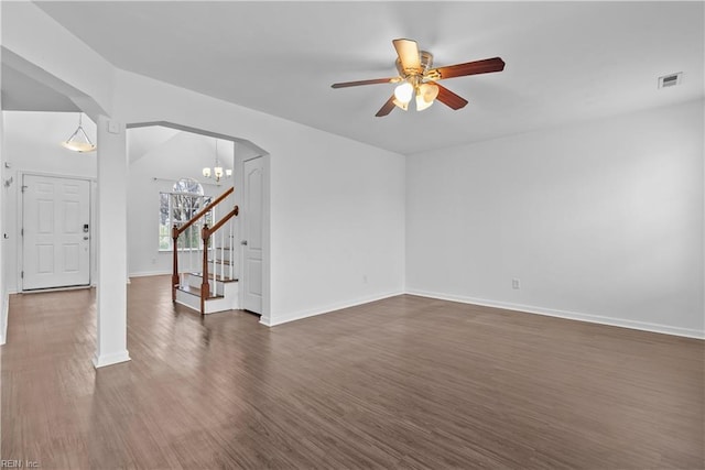 unfurnished living room featuring dark hardwood / wood-style floors and ceiling fan with notable chandelier