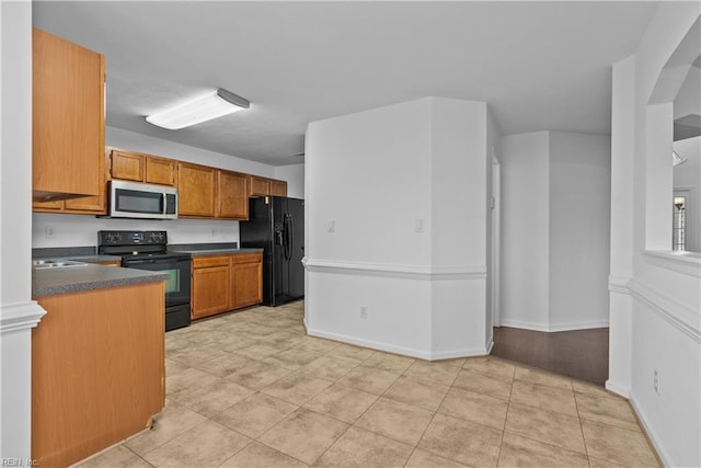 kitchen featuring light tile patterned flooring and black appliances