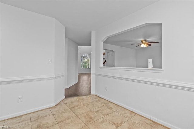 tiled spare room featuring ceiling fan