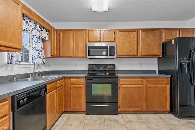 kitchen featuring sink, light tile patterned floors, and black appliances