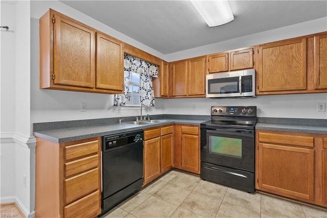 kitchen with sink, light tile patterned floors, and black appliances