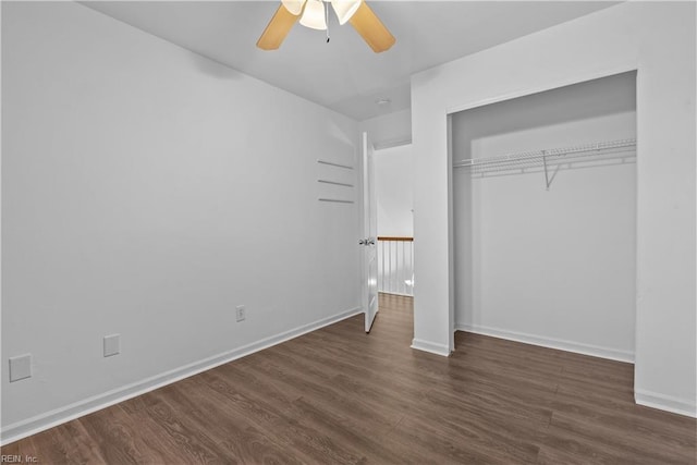 unfurnished bedroom with ceiling fan, dark hardwood / wood-style floors, and a closet