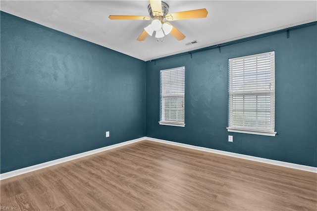 spare room featuring wood-type flooring and ceiling fan