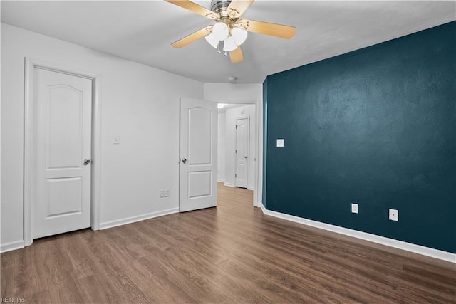 unfurnished room with ceiling fan and wood-type flooring