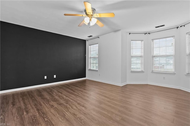 spare room featuring ceiling fan and hardwood / wood-style floors