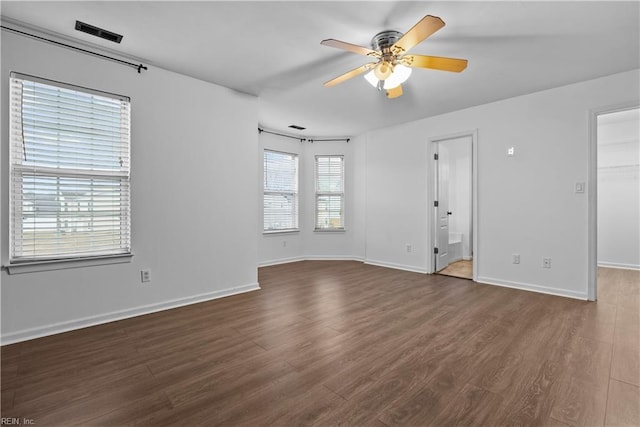 spare room featuring dark hardwood / wood-style floors and ceiling fan