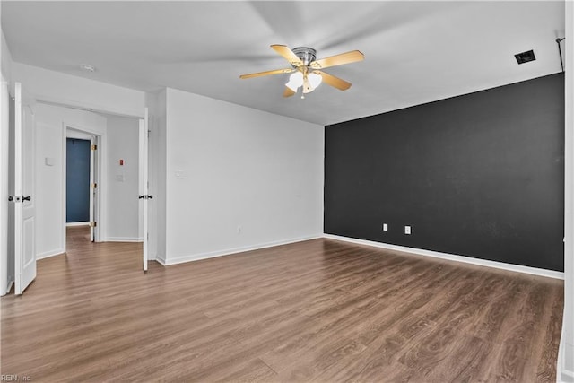 empty room featuring wood-type flooring and ceiling fan