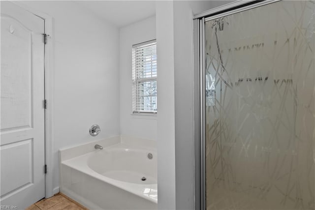 bathroom with independent shower and bath and tile patterned flooring