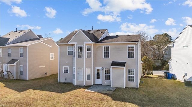 back of property with a patio and a lawn