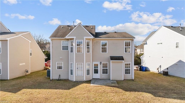 back of property with a patio area and a lawn