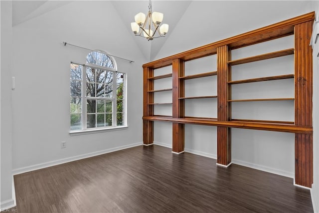 interior space with vaulted ceiling, an inviting chandelier, and dark hardwood / wood-style flooring