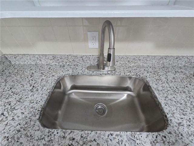 details featuring sink and light stone counters