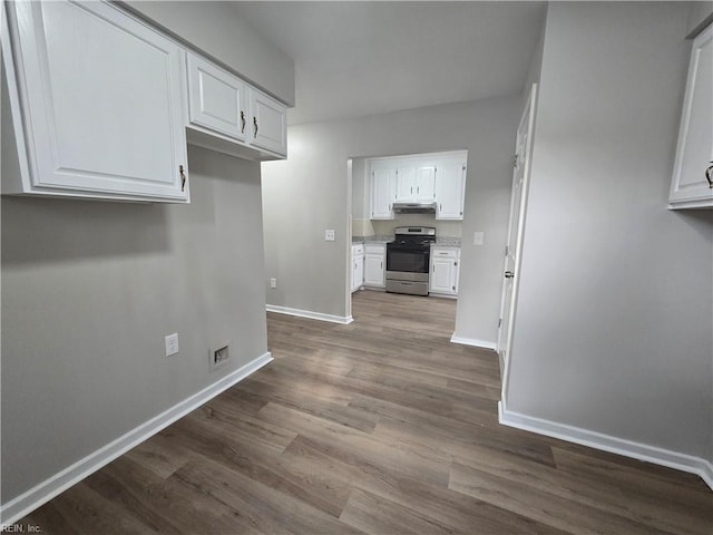 kitchen with white cabinetry, stainless steel stove, and hardwood / wood-style flooring