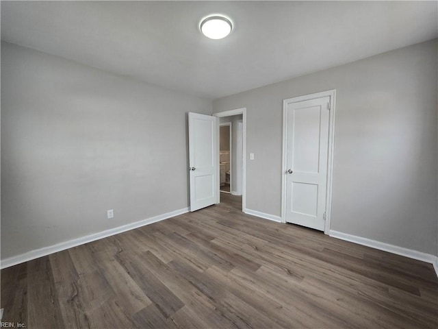 unfurnished bedroom with hardwood / wood-style flooring