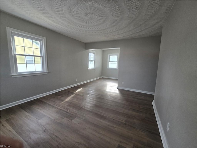 spare room with dark wood-type flooring