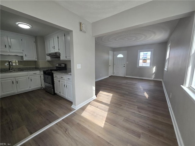 kitchen with white cabinetry, dark wood-type flooring, sink, and stainless steel gas stove