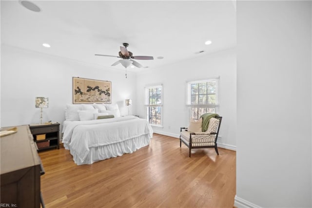 bedroom featuring crown molding, hardwood / wood-style floors, and ceiling fan