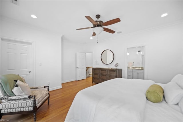 bedroom with crown molding, ensuite bath, ceiling fan, and light hardwood / wood-style floors