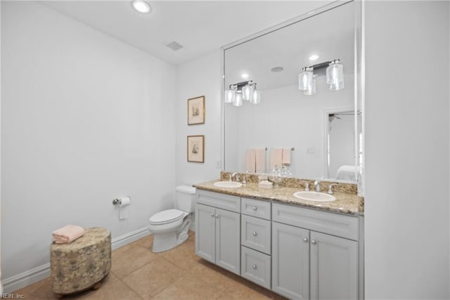 bathroom with vanity, tile patterned flooring, and toilet