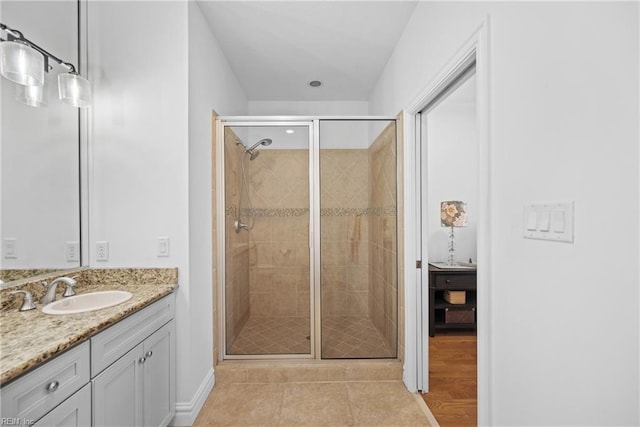 bathroom with tile patterned flooring, vanity, and a shower with shower door